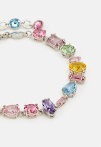 Colorful gemstone necklace featuring various shapes in pink, blue, green, yellow, and purple, set in silver-tone metal.
