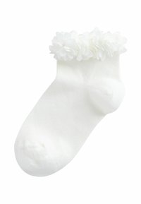 Fehér bokazokni fodros, virágmintás szegéllyel a szár körül, puha, bordázott anyagból készült.