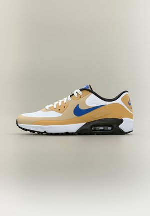 Baskets basses Nike Air Max en blanc, beige et bleu avec amorti à air visible et semelle en caoutchouc noir sur fond gris.