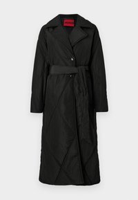 Long black quilted coat with wide collar, two buttons, and matching belt tied at the waist, labeled HUGO inside collar.