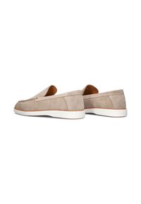 Beige suède instap schoenen met een ronde neus, witte rubberen zool en minimale stikdetails. Geen zichtbare hardware of accenten.