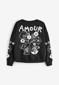 Fekete pulóver fehér virágmintás hímzéssel és "AMOUR" felirattal a hátsó részen. Hosszú ujjú, az oldalán virágmintákkal.