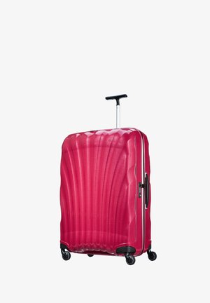 Hard-shell pink suitcase with a textured wave design, retractable handle, and four spinner wheels for easy maneuverability.