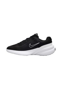 Zapatillas deportivas negras con parte superior de malla, suela blanca y un prominente logo de swoosh. Presentan una forma redondeada y acentos texturizados en la parte superior.
