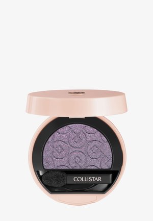 Compacto redondo rosa con sombra de ojos púrpura brillante, grabada con logotipos y un pequeño aplicador negro etiquetado como "Collistar".