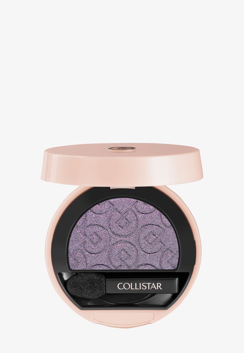 Round pink compact with shimmery purple eyeshadow embossed with logos and a small black applicator labeled "Collistar."