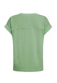 Chemise verte claire à manches courtes avec poignets repliés et couture horizontale au-dessus du dos.