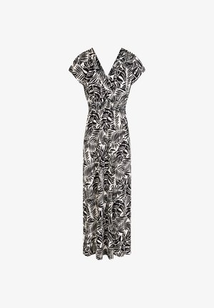 Musta-valkoinen trooppisten lehtien painokuvioinen haalarinpuku, jossa V-kaula-aukko, lyhyet hihat, kerrostettu vyötärö ja leveälahkeiset housut valkoisella taustalla.