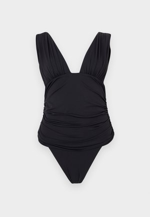 Μαύρο ολόσωμο μαγιό με βαθύ V-λαιμόκοψη, ρυθμισμένες λεπτομέρειες υφάσματος και ψηλές ανοίγματα στα πόδια, παρουσιάζεται σε απλό φόντο.