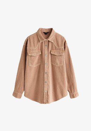 Light brown denim shirt with long sleeves, pointed collar, two front pockets, and silver snap buttons. Features a relaxed fit and durable texture.