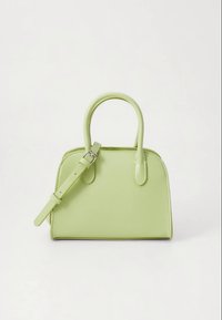 Light green vegan leather handbag with a structured shape, dual top handles, adjustable shoulder strap, and smooth texture.