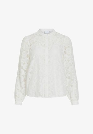 Blouse en dentelle blanche avec un col haut, des manches longues et une fermeture boutonnée à l'avant. Présente des motifs floraux, une texture transparente et des poignets élastiqués.