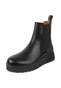 Stivaletto nero alla caviglia caratterizzato da una tomaia in pelle liscia, inserti laterali elastici e una suola in gomma nera testurizzata con un piccolo tacco.