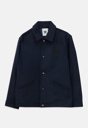 Navy fleece jacket with a collared neck, snap button closure, side pockets, and a textured letter "W" logo on the chest.