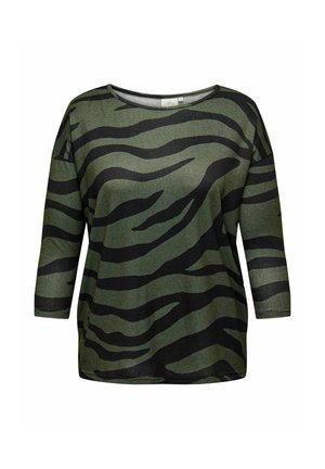 Chemise à manches longues, coupe ample, avec des rayures zèbre vertes et noires et un col rond sur fond blanc.