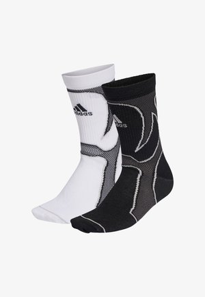 Zwart-witte atletieksokken met ribbels aan de bovenkant, mesh panelen en een gestructureerd materiaal met het merklogo op elke sok.