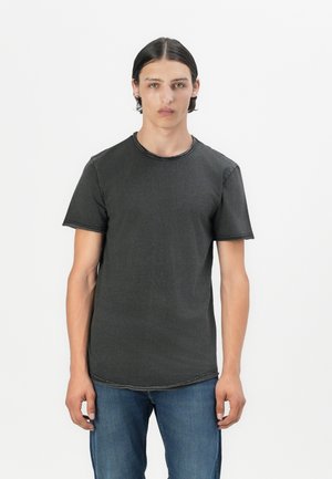 Dark gray t-shirt made from soft fabric, featuring a round neck, short sleeves, and subtle stitching details. Paired with blue jeans.