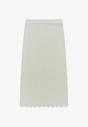 Strikket nederdel i lys grøn med et struktureret, chevron-mønster og en bølget kant. Har en tætsiddende talje og indviklet blonde-detalje i bunden.