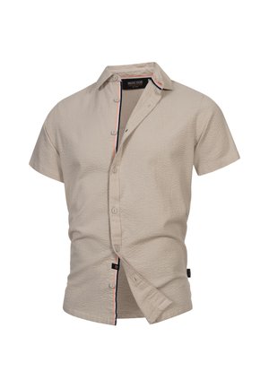 Kortärmad, beige skjorta i strukturerad tyg, med knapp framtill och kontrasterande randdetalj längs kragen och knäppningen.