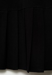 Black pleated skirt made of a soft fabric. Features uniform pleats and a seamless waistband, creating a smooth, elegant silhouette.