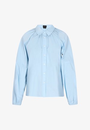 Soehe sinine nööbitud särk, mis on valmistatud siledast puuvillast. Omab ümarat kaelust, pikki varrukaid elastsete mansettidega ning peene volangiga detaile.