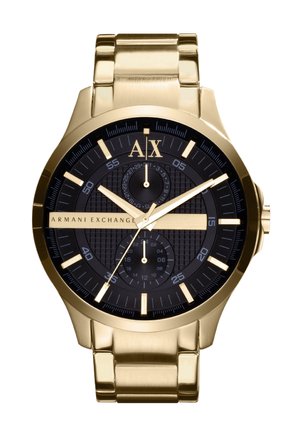 Złototona stal nierdzewna zegarek z czarną teksturowaną tarczą, świecącymi znacznikami godzin, subtarcze chronografu i wypolerowaną bransoletą.