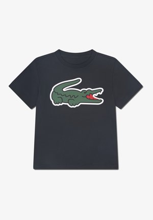 T-shirt en coton bleu marine avec un grand crocodile vert agrémenté d'accents rouges sur la bouche. Manches courtes et col rond.