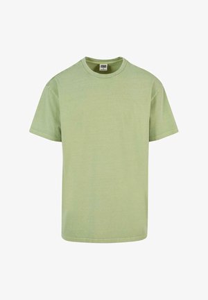 Világos zöld pamut póló rövid ujjal, kerek nyakkal és laza szabással. Simább textúra, látható minták vagy díszítések nélkül.