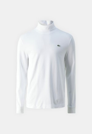 White long-sleeve turtleneck shirt made of soft fabric, featuring a small green embroidered logo on the chest and fitted cuffs.