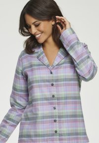 Button-up plaid shirt in pastel colors, featuring a collar, long sleeves, and a soft texture with purple, green, and gray patterns.