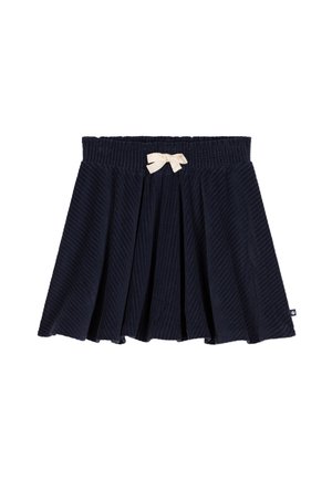 Marineblauwe corduroy rok met een brede elastische tailleband en een crèmekleurige strik aan de voorkant. Kenmerkt zich door plooien en een gestructureerd oppervlak.