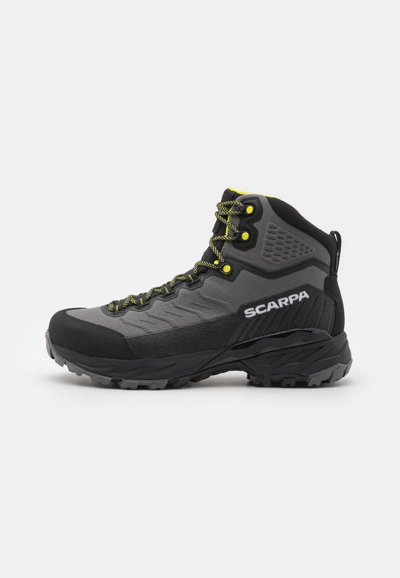 Black and grey hiking boot with textured fabric, bright yellow accents, reinforced toe, and rubber outsole featuring deep treads for traction.