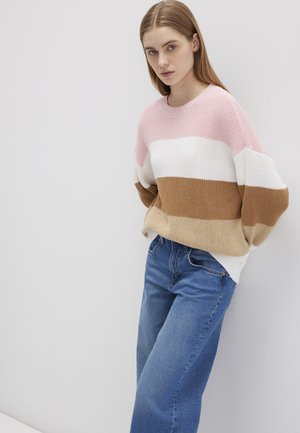 Knit sweater with pink, white, beige, and brown stripes. Relaxed fit with a wide neckline, paired with light blue denim jeans.