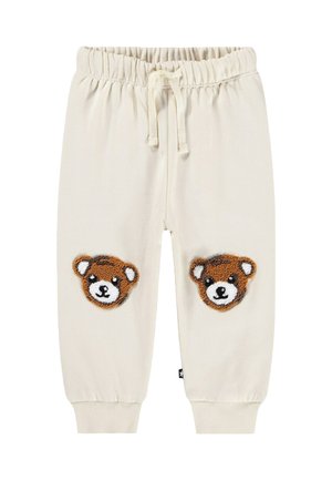 Krämfärgade sweatpants med elastiskt midjeband och dragsko, med två teddybjörn-applikationer på knäna. Ribbad mudd.
