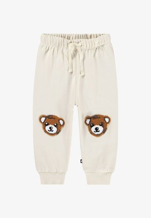 Crèmekleurige sweatpants met een elastische tailleband en trekkoord, met twee teddyberen-applicaties op de knieën. Geribde boorden.