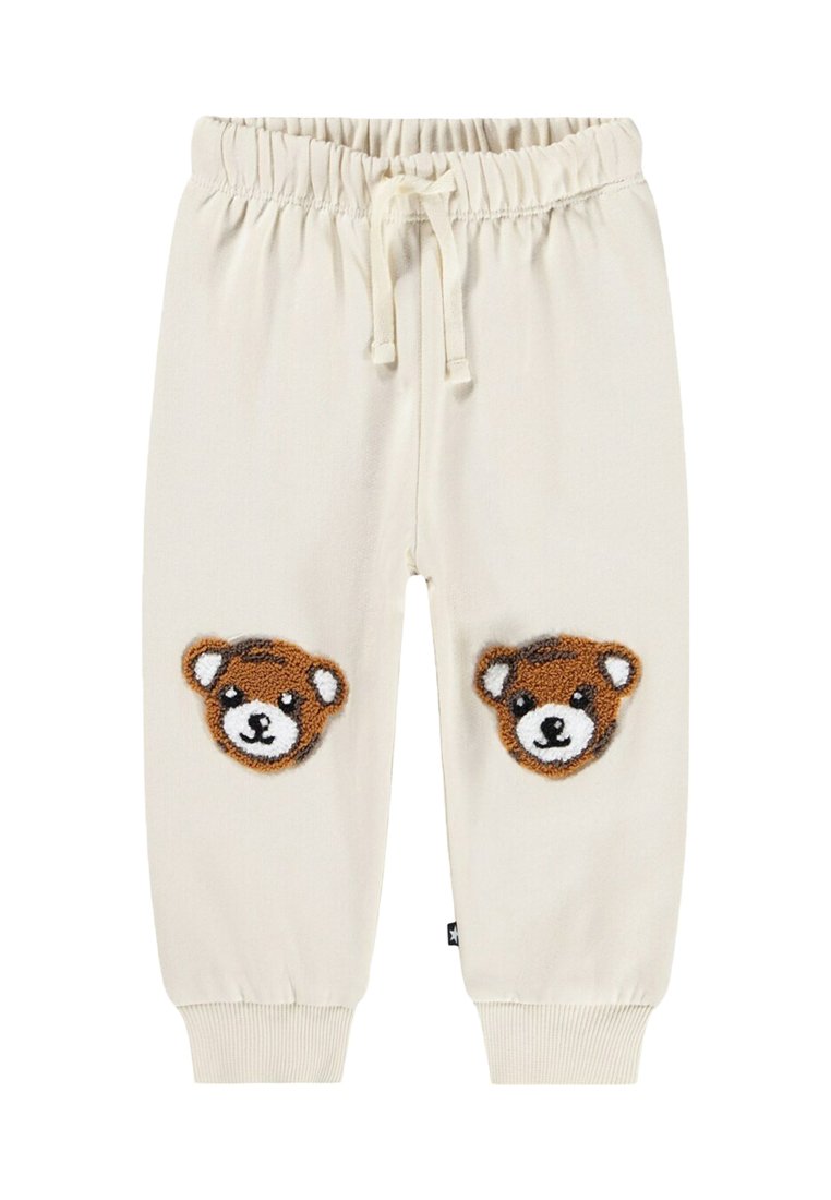 Krämfärgade sweatpants med elastiskt midjeband och dragsko, med två teddybjörn-applikationer på knäna. Ribbad mudd.