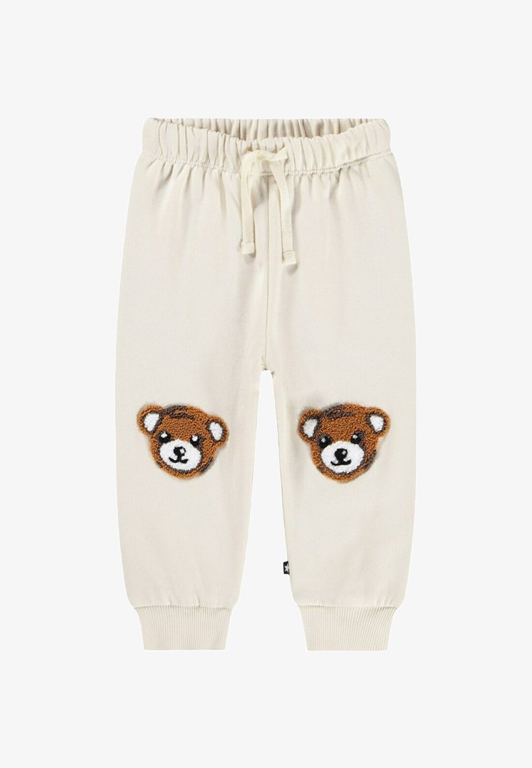 Crèmekleurige sweatpants met een elastische tailleband en trekkoord, met twee teddyberen-applicaties op de knieën. Geribde boorden.
