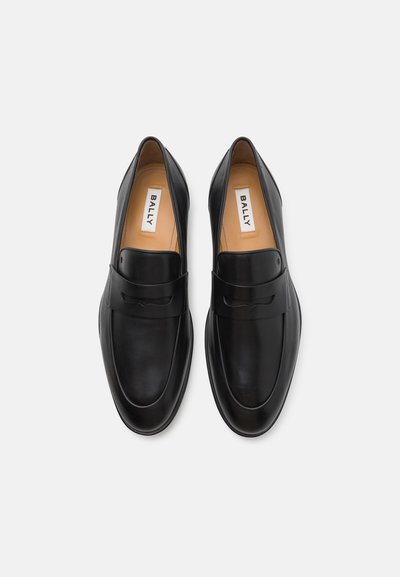 Black leather loafers with a smooth texture, featuring a front strap and subtle stitching details. Brand label read "BALLY" inside.