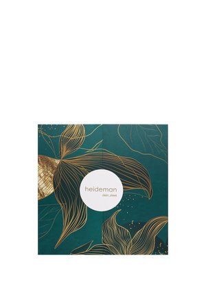 Groene verpakking met gouden lijntekeningen van bladeren en bloemen. Rond wit etiket met de tekst "heideman dein_steel" in het midden.