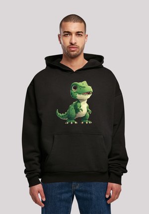 Black hoodie featuring a cartoon green T-rex with large eyes and a wide smile. Cotton blend material with a front pocket and ribbed cuffs.