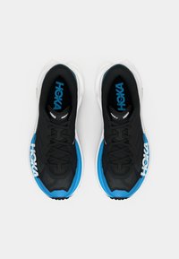 Black running shoes with blue accents, textured mesh upper, lace closure, and prominent white "HOKA" branding on the sides.