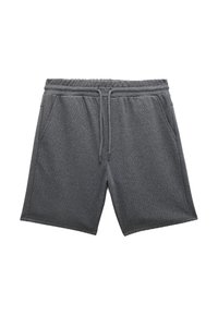 Graue Baumwoll-Sweatshorts mit elastischem Bund, Kordelzug und zwei Seitentaschen. Sie verfügen über eine strukturierte Oberfläche und ein lockeres Design.