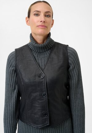 Black leather vest with a fitted design, featuring a V-neck, three buttons, and a smooth texture, worn over a gray ribbed turtleneck.