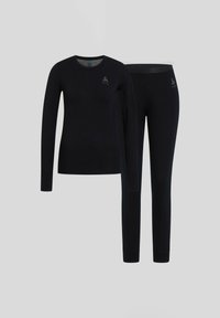 Black long-sleeve top and fitted pants made from soft fabric. Features minimal design and subtle logo detail on the top and pants.