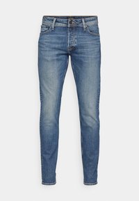 Tajta jeans i ljusblå denim, med ton-i-ton sömmar, fem fickor och en klassisk knäppning med knappar.