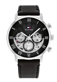 Orologio analogico nero con cassa in acciaio inossidabile argentato, meccanismi interni trasparenti, numeri romani e cinturino in pelle nera.