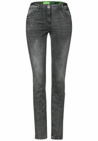 Jeans gris de corte slim fabricados en denim, con un ligero desgaste, diseño de cinco bolsillos y costuras verdes en contraste en la cinturilla.