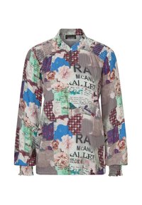 Mehrfarbige Jacke mit einem Viertelreißverschluss, die florale, textuelle und geometrische Muster auf leichtem Stoff aufweist. Mit elastischen Bündchen und Kragen.