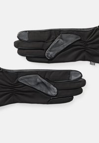 Black gloves made of soft fabric with leather accents on palms and fingertips, featuring gathered detail at wrists.