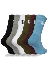 Chaussettes assorties en noir, gris, blanc, olive, marron et bleu, présentant une texture côtelée et un détail de logo sur le revers.